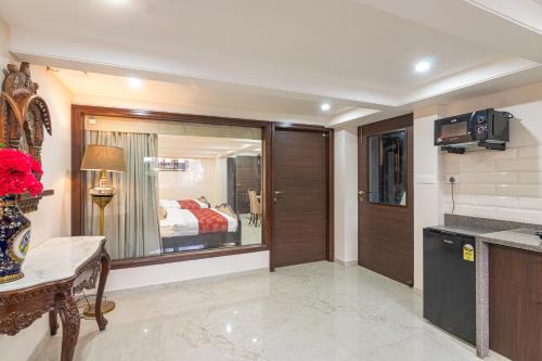a hotel room with a kitchen and a bedroom at Palm Residences and Suites in Jaipur