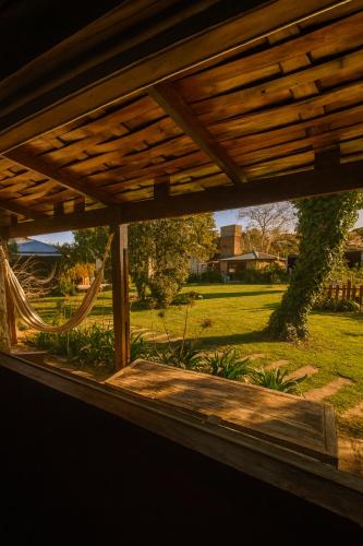 a view of a yard from a porch with a hammock at KEIKI Complejo Cabañas in La Porteña