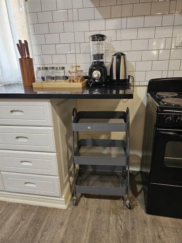 a kitchen with a black counter top with a appliance at Ahava Home in Lusaka