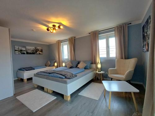 a bedroom with a bed and a desk and a chair at Ferienwohnung Meyer in Neukirchen vorm Wald