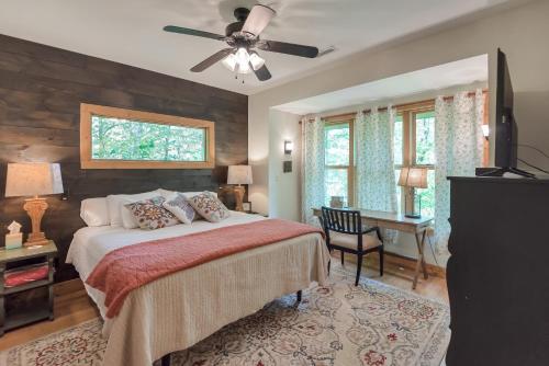 a bedroom with a bed and a ceiling fan at By The New River - Hot Tub - Fireplace - Covered Porch in Glendale Springs