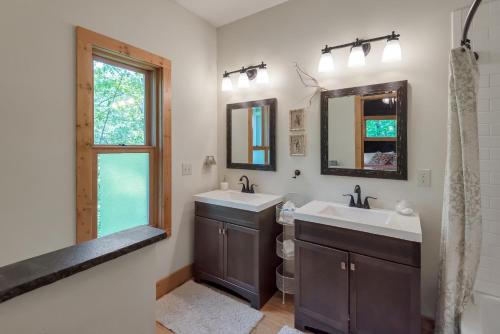a bathroom with two sinks and two mirrors at By The New River - Hot Tub - Fireplace - Covered Porch in Glendale Springs