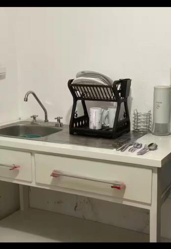 a kitchen counter with a drying rack next to a sink at Bonita casa en Oaxaca in Oaxaca City