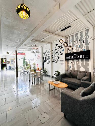 a lobby with a couch and tables in a building at Hotel y Arte Antigua by Amazing Guatemala Travel in Antigua Guatemala