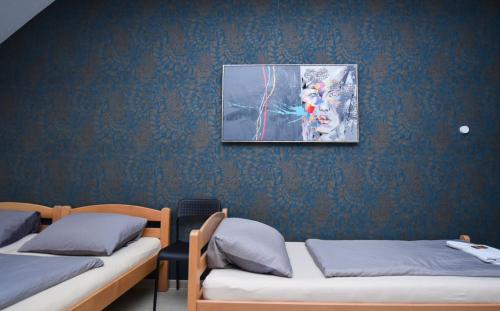 a room with two beds and a painting on the wall at Moderne Appartement in Nürnberg