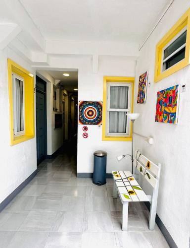 a hallway with a bench next to a door at Hotel y Arte Antigua by Amazing Guatemala Travel in Antigua Guatemala