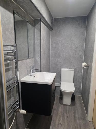 a bathroom with a sink and a toilet at MetroStay Manchester in Manchester