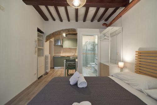 a bedroom with a bed with towels on it at Suite n14 - Open space in the heart of the city in Perugia