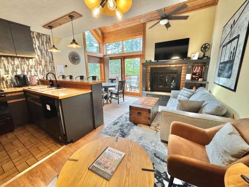 a kitchen and living room with a couch and a table at Ski-in Ski-out Townhome at Lutsen Mountain, Pool, Hot Tub, Fitness, Sauna and more! in Lutsen
