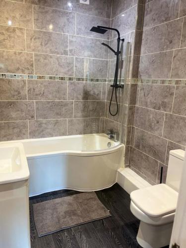 Un baño con bañera, inodoro y lavabo. en 2 Bedroom Property at sovereign House, en Keighley
