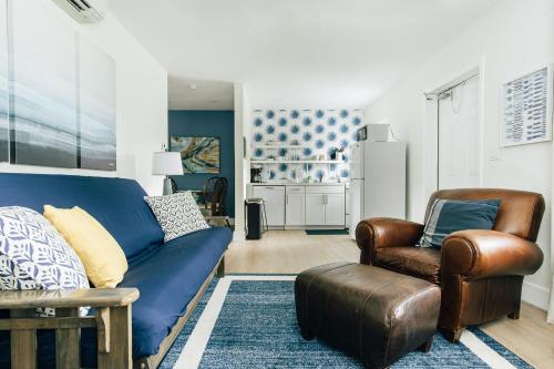 a living room with a blue couch and two chairs at New & Blue - 2 blocks to the beach in Pompano Beach