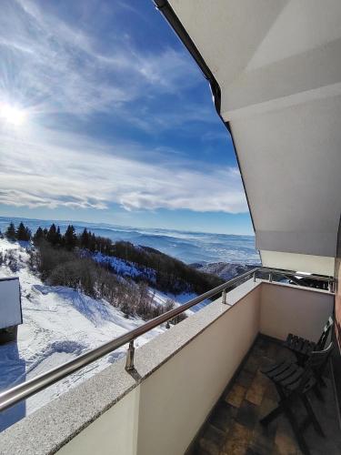 a view from the balcony of a house with snow at Ramondia, Kopaonik in Kopaonik