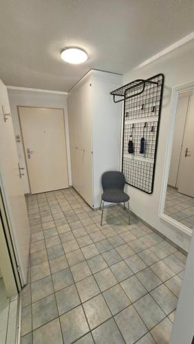 a empty room with a chair and a door at Premium Apartment mit Pilatus Sicht in Luzern
