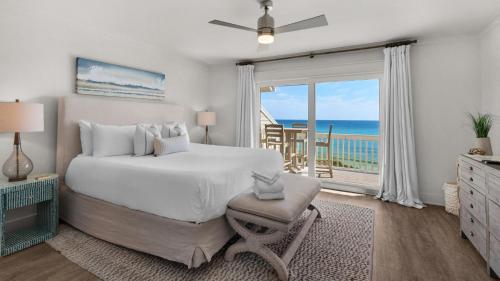 a bedroom with a bed and a view of the ocean at Seashadows Townhomes 4 in Seacrest