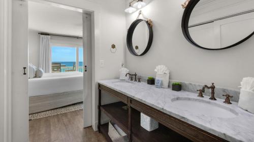 a white bathroom with a sink and a mirror at Seashadows Townhomes 4 in Seacrest