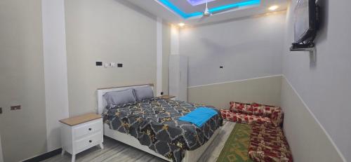 a small bedroom with a bed and a couch at Arhiba Guest House አርሂባ እንግዳ ማረፊያ 