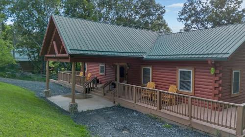 a log cabin with a deck and a metal roof at Mountain Views - Firepit - Gas Fireplace - Sleeps 15 in Grassy Creek
