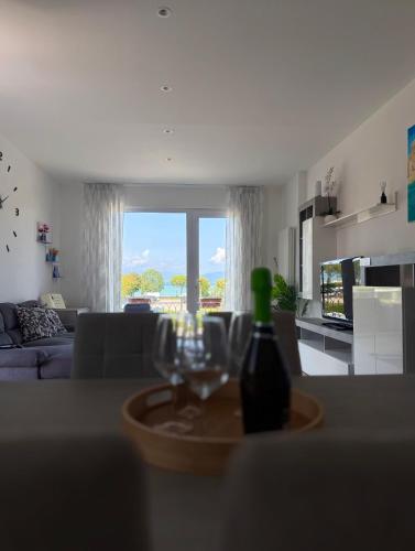 a living room with a bottle of wine and a glass at Cecilia Sirmione Appartamento in Sirmione