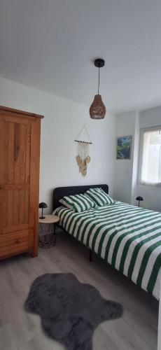 a bedroom with two beds and a window at Appartement cosy en plein centre ville in Saint-Pierre-du-Regard