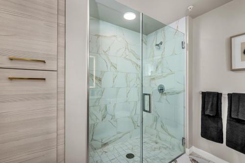 a shower with a glass door in a bathroom at Luxury by the Beach with Pool, Gym, Game Room in Los Angeles