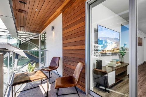 an office with a glass door and a desk and chairs at Luxury by the Beach with Pool, Gym, Game Room in Los Angeles