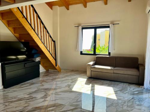 a living room with a couch and a window at 2 BEDROOM APARTMENT iN ViLLA MATEKA in Roquebrune-Cap-Martin