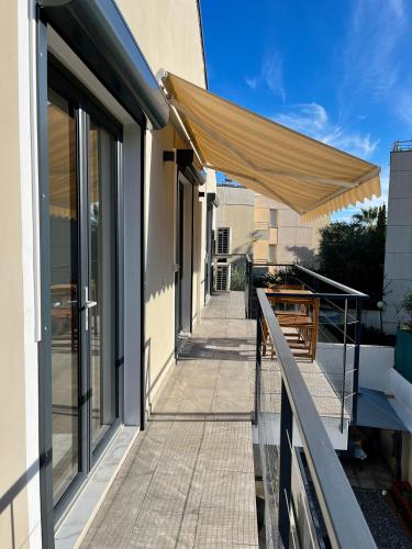 a patio with a tan umbrella on a building at 2 BEDROOM APARTMENT iN ViLLA MATEKA in Roquebrune-Cap-Martin