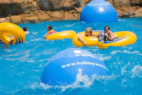 a group of people in the water on inflatables at Holiday Premium Resort in Benalmádena