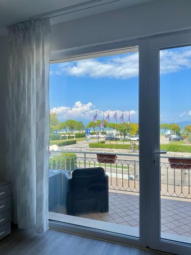 a sliding glass door with a view of a park at Cecilia Sirmione Appartamento in Sirmione