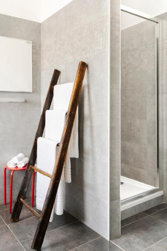 a stack of towels in a bathroom with a shower at Residence Campagnole in Vicolungo