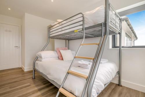 a bedroom with a bunk bed and a ladder at 3 Bed in Tintagel oc-e32938 in Tintagel