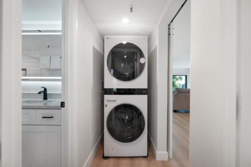 a laundry room with a washer and dryer at Updated direct oceanfront, ground floor condo with a heated pool and beach access in Bottle Island