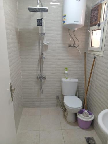 a bathroom with a shower and a toilet and a sink at TAVIRA Rass Suder"For Family" in Raʼs Matarma