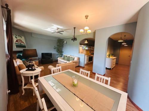 a kitchen and living room with a table and chairs at Chanel Garden Relaxation Home in Formello