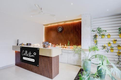 a restaurant lobby with a counter with plants at Super Collection O Jaigaon Near Bhutan Gate in Phuntsholing