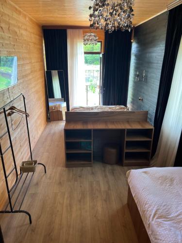 a bedroom with two beds and a chandelier at Balda Novel House in Martvili