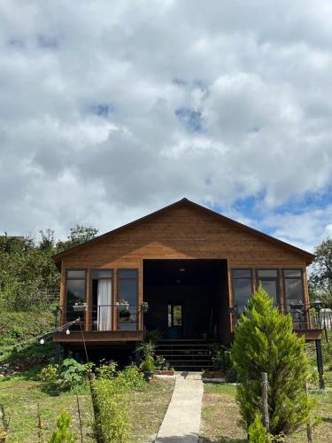 a small house with a porch and a balcony at Balda Novel House in Martvili