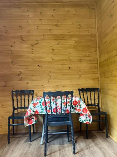 two chairs and a table with a table cloth at Balda Novel House in Martvili
