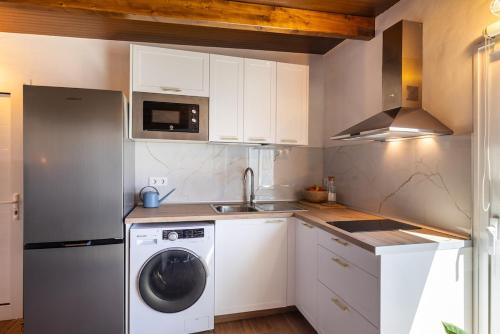 a kitchen with a washing machine and a sink at Penthouse with a View in El Palmital