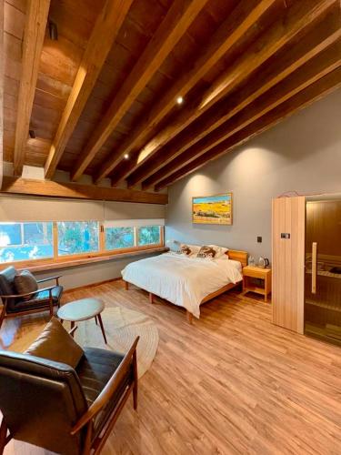 a large bedroom with a bed and a couch at Pure in Mexico City