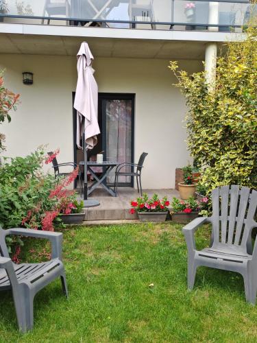 two chairs sitting in the grass in a yard at Le balcon des cimes in Adast