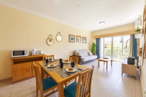 a kitchen and living room with a table and chairs at A52 - Quintão Apartment in Portimão in Portimão