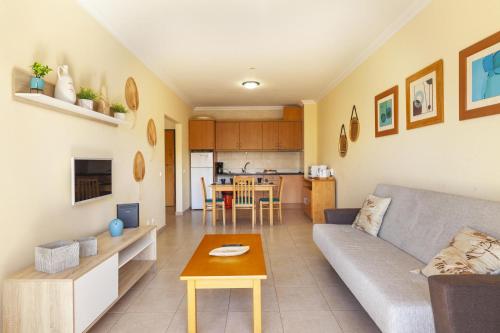 a living room with a couch and a table at A52 - Quintão Apartment in Portimão in Portimão