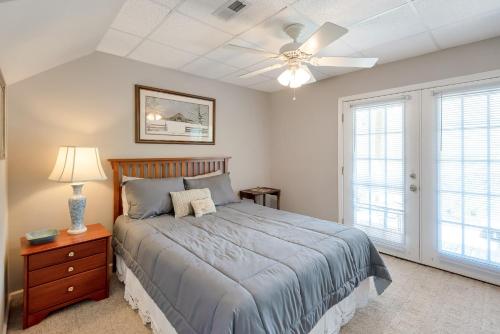 a bedroom with a bed and a ceiling fan at 3 Bed Cabin Overlooking the New River-- HOT TUB, Fire Pit, Dogs OK in Obids