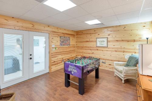 a game room with a foosball table in the center at Lazy Dog Log Cabin, Hot Tub, Fishing Lake, New River Access, Foosball in Wagoner