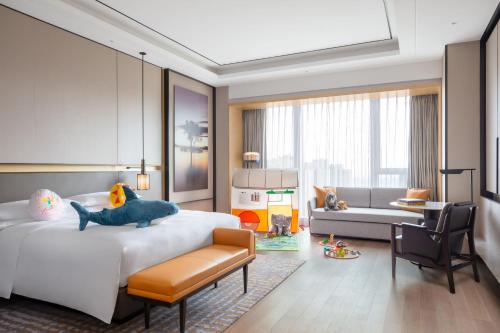 a bedroom with a bed with a stuffed animal on it at Sheraton Shanghai Fengxian in Shanghai