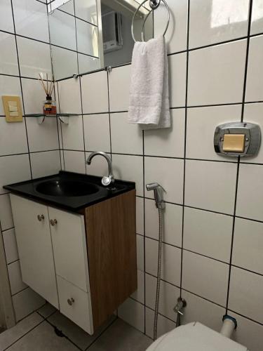 a bathroom with a sink and a toilet at Hotel Paradão Linhares in Linhares