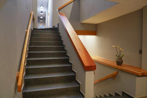 a staircase in a house with wooden railings at Pure in Mexico City