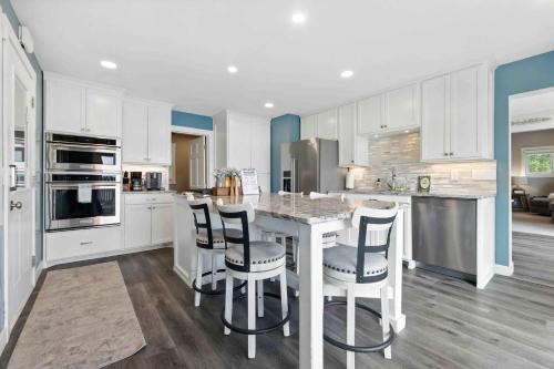 a kitchen with white cabinets and a table and chairs at Hartley Lake Hideaway - The Perfect Getaway! in Brainerd