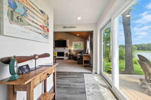 a home office with a desk and a large window at Hartley Lake Hideaway - The Perfect Getaway! in Brainerd